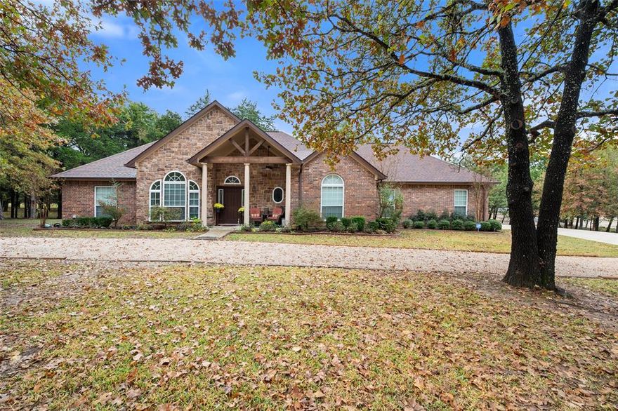 Welcome to 403 Arrowhead Point in Sweetwater Ranch, where peaceful lake living meets refined comfort on 1.21 beautifully treed acres near Richland Chambers Lake.

Built in 2019, this thoughtfully designed 3-bedroom, 2.5-bath lake house blends warm textures and timeless finishes with an open, airy layout made for gathering. Vaulted ceilings and a floor-to-ceiling stone fireplace create an inviting focal point in the living room, while natural light pours in and highlights the rich wood flooring throughout the main living spaces.

The kitchen is both functional and beautiful, featuring polished granite countertops, custom-stained solid wood cabinetry with crown molding, stainless steel double ovens, an electric cooktop, large island, breakfast bar, and abundant built-ins. It’s the kind of space where holidays are hosted, stories are shared, and everyday moments feel special.

The private primary suite offers a relaxing retreat with a tray ceiling, spacious walk-in closet, and an ensuite bath complete with dual sinks, granite counters, linen storage, and a separate tiled shower. Two additional bedrooms, a dedicated office, full bath, and half bath provide flexibility for guests, hobbies, or working from home.

Step outside to a covered back deck overlooking a generous backyard and fire pit area—perfect for slow mornings with coffee or evenings under the Texas sky. With a circular driveway, oversized side-entry garage with workshop space, underground utilities, and access to the community boat ramp, this Sweetwater Ranch property delivers both privacy and lake lifestyle convenience.

Whether you're looking for a full-time residence or a weekend escape near Richland Chambers Lake, this home offers space, style, and the kind of setting that makes coming home feel like a getaway.