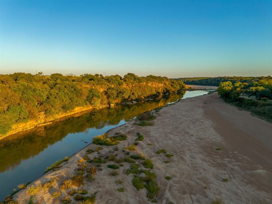 Just over an hour from Dallas Fort Worth, discover an elevated slice of Texas at River Canyon Ranch an intimate, gated ranch community with coveted, private Brazos River access from your own property plus use of a five-acre owners’ river park. This is where wide-open skies meet the 360° ridgelines of the Palo Pinto Mountains, and where weekend escapes turn into lasting legacies. Positioned in a thoughtfully growing enclave, this homesite blends serenity with smart investment. Low carrying costs are assured by Ag Exempt status through the community’s Cattle Grazing Association, and everyday ease comes standard with paved roads, so you can dream big and start building sooner. Design a modern ranch retreat, a full-time residence, or a high performing short-term rental, the setting is tailor made for indoor outdoor living, stargazing decks, and lazy afternoons by the river. Nature is your amenity package, launch kayaks, cast a line, wander canyon trails, or simply watch the sun melt over the hills. Beyond the gates, you’re close enough to DFW for spontaneous getaways yet far enough to feel worlds apart, ideal for buyers seeking Texas riverfront land, gated acreage, low tax ranch property, and Brazos River real estate with year-round appeal. Opportunities like this are limited as River Canyon Ranch continues to mature. Secure your spot on the river, capitalize on the area’s momentum, and create the retreat you’ve imagined.