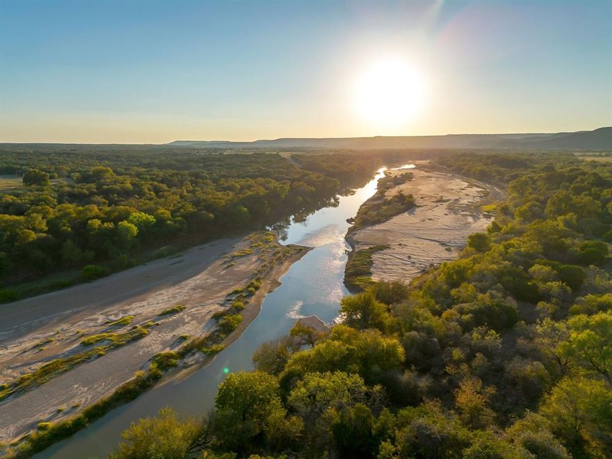 Just over an hour from Dallas Fort Worth, discover an elevated slice of Texas at River Canyon Ranch an intimate, gated ranch community with coveted, private Brazos River access from your own property plus use of a five-acre owners’ river park. This is where wide-open skies meet the 360° ridgelines of the Palo Pinto Mountains, and where weekend escapes turn into lasting legacies. Positioned in a thoughtfully growing enclave, this homesite blends serenity with smart investment. Low carrying costs are assured by Ag Exempt status through the community’s Cattle Grazing Association, and everyday ease comes standard with paved roads, so you can dream big and start building sooner. Design a modern ranch retreat, a full-time residence, or a high performing short-term rental, the setting is tailor made for indoor outdoor living, stargazing decks, and lazy afternoons by the river. Nature is your amenity package, launch kayaks, cast a line, wander canyon trails, or simply watch the sun melt over the hills. Beyond the gates, you’re close enough to DFW for spontaneous getaways yet far enough to feel worlds apart, ideal for buyers seeking Texas riverfront land, gated acreage, low tax ranch property, and Brazos River real estate with year-round appeal. Opportunities like this are limited as River Canyon Ranch continues to mature. Secure your spot on the river, capitalize on the area’s momentum, and create the retreat you’ve imagined.