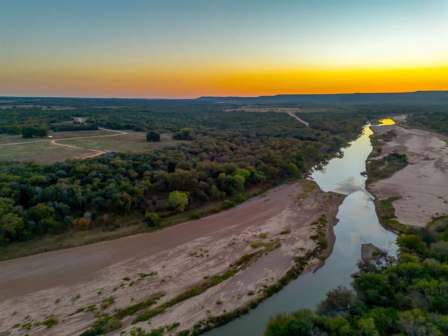 Just over an hour from Dallas Fort Worth, discover an elevated slice of Texas at River Canyon Ranch an intimate, gated ranch community with coveted, private Brazos River access from your own property plus use of a five-acre owners’ river park. This is where wide-open skies meet the 360° ridgelines of the Palo Pinto Mountains, and where weekend escapes turn into lasting legacies. Positioned in a thoughtfully growing enclave, this homesite blends serenity with smart investment. Low carrying costs are assured by Ag Exempt status through the community’s Cattle Grazing Association, and everyday ease comes standard with paved roads, so you can dream big and start building sooner. Design a modern ranch retreat, a full-time residence, or a high performing short-term rental, the setting is tailor made for indoor outdoor living, stargazing decks, and lazy afternoons by the river. Nature is your amenity package, launch kayaks, cast a line, wander canyon trails, or simply watch the sun melt over the hills. Beyond the gates, you’re close enough to DFW for spontaneous getaways yet far enough to feel worlds apart, ideal for buyers seeking Texas riverfront land, gated acreage, low tax ranch property, and Brazos River real estate with year-round appeal. Opportunities like this are limited as River Canyon Ranch continues to mature. Secure your spot on the river, capitalize on the area’s momentum, and create the retreat you’ve imagined.