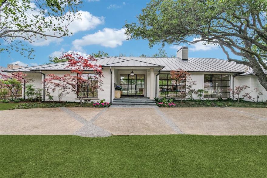 Builder owners completely reimagined and updated this home in 2013 to make it a modern masterpiece.  This home is light & bright with it's steel windows & soaring, beamed ceiling in the main living area that is open to the wet bar, kitchen & dining room.  The accordion Fleetwood window to the resort-style back yard enables entertaining inside & out.  Large, see through pecky cypress lined fireplace separates the living from the chef's kitchen.  The kitchen is complete with bar area with ice maker & refrigerator and seating, large island, open shelving flanking the wolf gas range, large wine refrigerator, warming drawers and Sub Zero.  Dining room overlooks the tree lined front and leads to another living room with fireplace.  2 bedrooms, one of which could be an office,  on this side of the house share a bathroom.  The primary bedroom with sitting area, dual baths & closets overlooks the backyard and pool. This side of the home also has 2 bedrooms with a shared bath. Not to be missed!