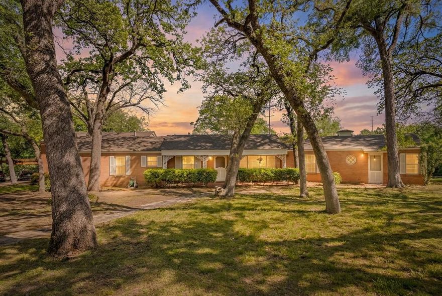 Welcome to this mid-century beauty found in the one and only, historic Oakhurst Neighborhood. When you drive up the hill into the cul-de-sac, you'll be face to face with this iconic home. The driveway goes almost to the back of the 1.3 acre lot where there is ample parking, 3 covered spots and an additional 2 car garage. This 1.3 acre lot is complete with mature oaks, a covered front porch and a massive deck on the back overlooking the cliffside... What a view! From the main entry you will see that everything has been perfectly preserved from the 1960's remodel. A few things that stand out are the oversized windows with a view of the private backyard, the 2-way fireplace, the built in TV and record player, and of course the terrazzo tile floors. When you view the home, please take a moment to look at the downtown skyline from the front yard. The seller is the second owner of this historic piece of art on Smilax Ave and has treated it with care, it's truly exceptional.
