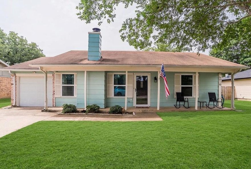 Welcome home to this charming Arlington retreat where comfort, character, and everyday living come together effortlessly. Nestled beneath mature shade trees on a quiet residential street, this beautifully maintained home offers inviting curb appeal with its soft coastal inspired exterior, covered front porch, and warm, welcoming atmosphere. Imagine slow mornings with coffee on the porch swing and relaxing evenings under the Texas sky. Inside, the home feels bright, airy, and thoughtfully updated with stylish flooring throughout, soft designer tones, and abundant natural light. The spacious living room centers around a stunning brick fireplace that creates the perfect gathering space for cozy movie nights, game days, or entertaining friends and family. The kitchen blends charm and functionality with crisp white cabinetry, sleek stainless steel appliances, and a striking blue mosaic backsplash that adds personality and style. Nearby, the dining nook offers the perfect setting for casual dinners, morning pancakes, or intimate holiday gatherings.
The primary suite is a peaceful retreat featuring calming tones, generous space, and a beautifully updated sliding barn door leading into the bath with dual vanities and warm wood cabinetry. Secondary bedroom are equally inviting and versatile, ideal for guests, kids, a home office, or creative space.
Step outside and discover the true lifestyle feature of this home: an expansive covered backyard deck designed for year-round enjoyment. Whether you're hosting weekend barbecues, relaxing with a glass of wine, watching the kids play, or enjoying evenings around a firepit, this backyard was made for gathering and making memories. The large yard, mature trees, and added storage shed complete the outdoor experience. Conveniently located near shopping, dining, parks, and commuter routes, this home offers the perfect blend of cozy charm and everyday convenience, a place that simply feels good the moment you arrive.