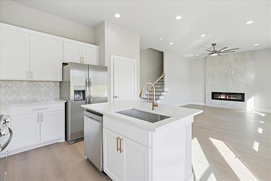 Tucked into a quiet pocket of Waxahachie, 113 Church St is the kind of home that feels intentional from the moment you walk in. Built new with a thoughtful layout and finishes that feel warm and current, this four bedroom, three and a half bath home offers 1,892 square feet designed around real life, not just square footage. Natural light moves easily through the space, highlighting soft neutral tones and brushed gold hardware that add character without overpowering the design.

The main living area feels open yet grounded, making it easy to picture slow mornings, relaxed evenings, and gatherings that feel effortless. The kitchen sits at the heart of the home with clean white cabinetry, a generous island, stainless steel appliances, and gold accents that bring a subtle layer of personality. Just off the front of home, the primary suite is privately positioned on the main level, offering a quiet retreat with a spacious walk in closet and a beautifully finished bathroom featuring dual sinks and a glass enclosed shower that feels calm and refined.

Upstairs, the layout continues to make sense. Two bedrooms share a Jack and Jill bathroom that supports shared living while still offering privacy, and a fourth bedroom with access to a full bath adds flexibility for guests, a home office, or a creative space.  A major bonus in this home is the attic space. With its size, height, and easy access, it presents an opportunity for future expansion, additional storage, or a finished bonus area, giving buyers room to grow without having to move.

Outside, the home offers clean curb appeal and a fenced backyard with plenty of room to relax, play, or entertain. The location places you just minutes from downtown Waxahachie, local shops, dining, parks, and community events, while still providing an easy commute and everyday convenience.