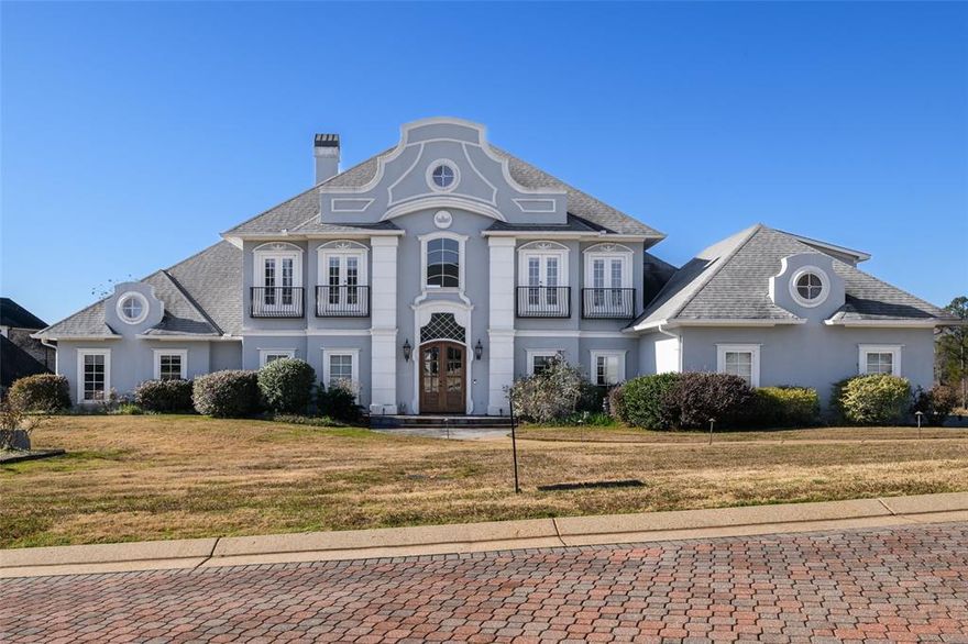 Stunning custom built home with large double lot!  Attention to details abound throughout this spacious home that also has two massive bedrooms downstairs as well as two full and one half baths down.  Gorgeous new wood front doors enter to a beautiful foyer with a fabulous crystal chandelier.  Living room has imported  brazilian granite flooring and beautiful built ins, with wall of windows overlooking the large, terraced backyard.  Kitchen dining, plus a separate dining room and a large den area.  Office, study, bonus room and excellent walk in attic space.  Kitchen has beautiful custom cabinetry and tons of counter space!  This home also includes an enclosed room for hot tub. Also, don't miss the second kitchen!   Excellent storage space and great closet space too.  This is a one of a kind home!