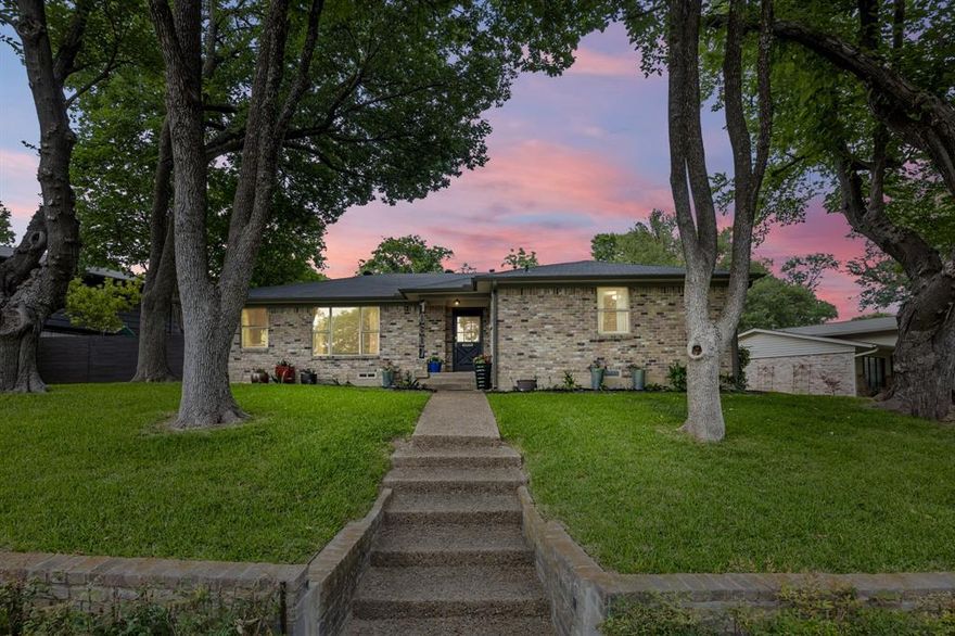 Immaculate pier-and-beam home in highly sought-after Lochwood, thoughtfully updated and truly move-in ready! Situated on a beautiful tree-lined street with exceptional curb appeal and towering mature trees, this charming residence offers the ideal blend of character and modern comfort. An inviting floor plan welcomes you with formal living and dining spaces upon entry, flowing seamlessly into a spacious rear family room that opens naturally to the renovated kitchen. The kitchen features freshly painted 42” shaker-style cabinetry, stunning new quartz countertops, a 2025 Frigidaire 5-burner gas range, new vent hood, stainless sink, and sleek modern faucet. Just beyond is an oversized 10’ x 6’ laundry room offering abundant storage and functionality. The private bedroom wing includes three bedrooms, highlighted by a generous 15’ x 13’ primary suite with a large walk-in closet. The beautifully updated primary bath showcases quartz countertops and an oversized shower with contemporary finishes and sliding glass enclosure. Enjoy the low-maintenance backyard, enclosed by a wood privacy fence and complemented by the attached 2-car garage featuring an impressive built-in storage system. Additional improvements include new carpet 2025, fresh interior paint, 2024 AC compressor, 2015 fence, and 2019 roof and gutters. Lochwood was recently recognized as a DBest Neighborhood, beloved for its majestic trees, lush greenbelts, and scenic creeks. Residents enjoy access to Lochwood Park featuring walking trails, tennis and pickleball courts, playground, basketball court, and a covered party pavilion. Ideally located just minutes from White Rock Lake, Dallas Arboretum and Botanical Garden, and some of East Dallas’ favorite local restaurants and cafes.