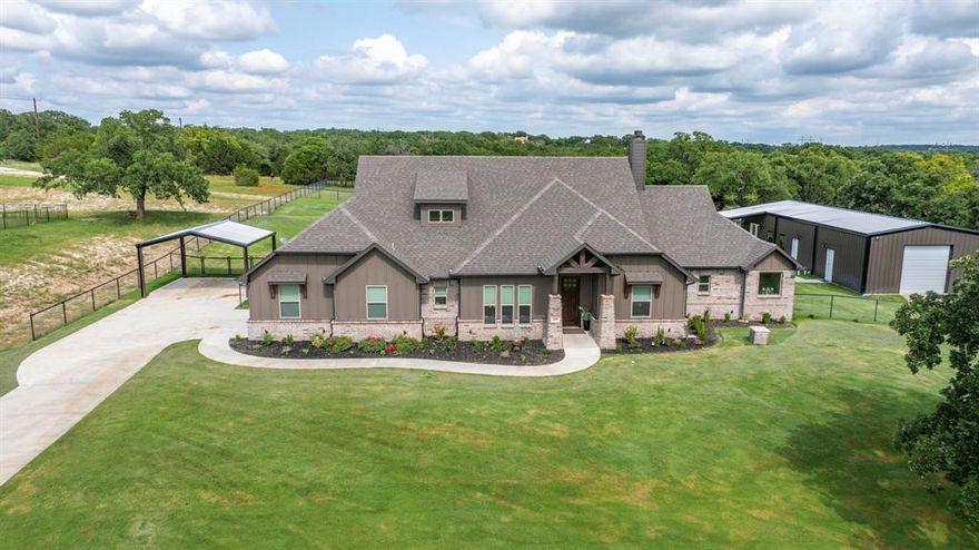 Stunning Country Home with Party Barn on 2 Acres in North Parker County, TX. This new and highly upgraded home sits on 2 pristine acres, surrounded by mature Post Oak trees. Great curb appeal and a long driveway set back from the street, this property offers both privacy and charm. Step inside to a spacious interior featuring an open floor plan, ideal for entertaining and everyday living. Just off the entryway is a dedicated office, perfect for remote work or study. The main living area has multiple windows that overlook the backyard and bring in abundant natural light. The thoughtfully designed split floorplan includes 3 bedrooms and 3 full bathrooms, allowing each bedroom to enjoy its own private bath. The home has been extensively updated in the past year with modern touches throughout, including a whole-home water filtration system, reverse osmosis at the kitchen sink, new built-in shelving, updated lighting, and updated cabinet hardware across the home. A major selling point is the massive party barn and shop space that adds an additional 1,000 square feet of heated and cooled living area complete with a secondary full kitchen and half bath, making it ideal for hosting guests, events, or creating a guest suite or home gym. There’s also a 20x25 workshop attached to the barn, on top of the houses already oversized two-car garage and two-car carport. Step outside and enjoy one of the two large porches overlooking 1.2 acres of fresh sod that has been laid, supported by a full sprinkler system covering more than an acre in both the front and backyard. The fully fenced and cross-fenced yard includes custom metal pipe fencing and gates in both the front and backyard perfect for kids, pets, or livestock. Whether you have horses or farm animals, the setup is ready for you.  At the very back of the property there are huge Post Oaks, and a wet weather creek for your kids to explore! This rare chance to get into a turn-key property with all the extras already there!