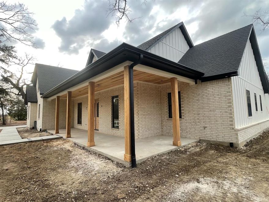 Unique and gorgeous WATERFRONT home being built on Richland Chambers Lake. It is a sleek modern farmhouse style home with an open plan. The lot is heavily wooded and feels very secluded. The home will have many high end features such as vaulted ceilings with white oak wood beams, custom shaker cabinets and trim, quartzite countertops, white oak hardwood floors in most areas, custom tile in wet areas, 8 foot tall interior doors, Pella high efficiency windows, open cell foam insulation throughout, insulated garage door, Cat 5 wiring and an oversized 2 car garage of about 650 square feet. The builder decided to add the optional bonus room and full bath shown in the floor plan photos. This added several hundred square feet.  Roof, HVAC, electrical, sheetrock, and windows are installed. Most cabinets are installed and flooring is starting in a few days. There is lake access in one corner of the property. (see photo) You can build a dock if you like. Current estimated completion is April 2026.