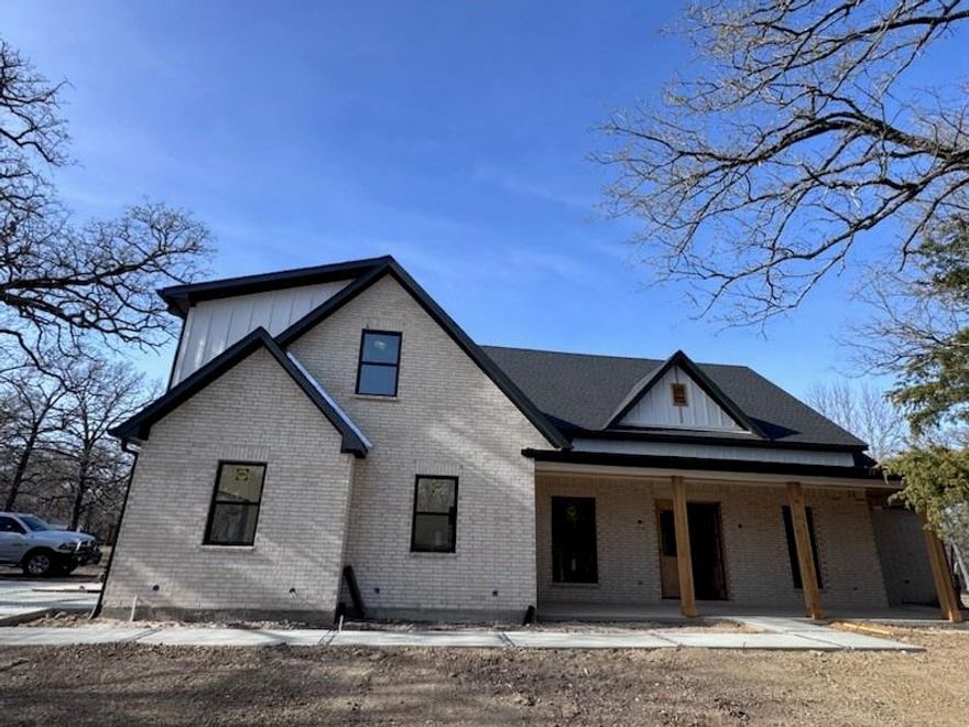 Unique and gorgeous WATERFRONT home being built on Richland Chambers Lake. It is a sleek modern farmhouse style home with an open plan. The lot is heavily wooded and feels very secluded. The home will have many high end features such as vaulted ceilings with white oak wood beams, custom shaker cabinets and trim, quartzite countertops, white oak hardwood floors in most areas, custom tile in wet areas, 8 foot tall interior doors, Pella high efficiency windows, open cell foam insulation throughout, insulated garage door, Cat 5 wiring and an oversized 2 car garage of about 650 square feet. The builder decided to add the optional bonus room and full bath shown in the floor plan. This added several hundred square feet. Roof, HVAC, electrical, sheetrock, and windows are installed. Most cabinets are installed and flooring is almost complete. There is lake access in one corner of the property. (see photo) You can build a dock if you like. Current estimated completion is April 2026.