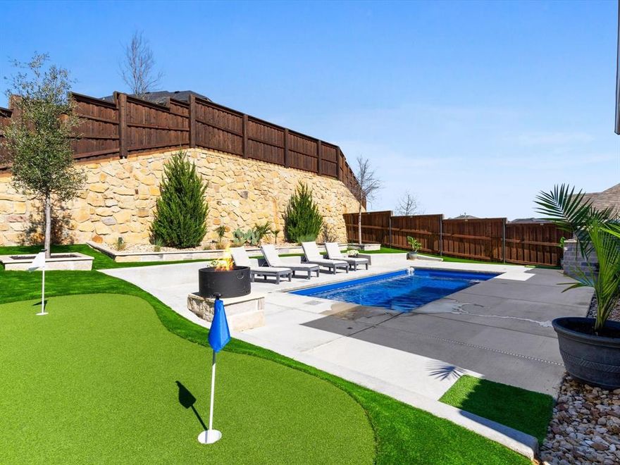 Vacay every day! Dive into your own private oasis this summer in this curated, like new home designed for comfort and outdoor living, offering a range of interior and exterior enhancements. Inside, the open living space features LED recessed lighting with a night light feature, and statement chandeliers above the pool table and grand foyer. A stunning 12-light spiral raindrop pendant chandelier with a dramatic high-ceiling design welcomes guests upon entry. While engineered hardwood flooring in the upstairs game room, office, guest bedroom, and primary bedrooms  complement the hardwood stairs. The kitchen is centrally located and features a high-capacity iSpring tankless reverse osmosis water filtration system for fresh drinking water. The garage features epoxy flooring, insulated doors, hexagon LED lighting, and a mini-split ac-heat pump for climate control.

The backyard is designed for entertaining and effortless living with a sparkling, fiberglass pool featuring 2 deck jets and 4 umbrella holders, surrounded by artificial turf with antimicrobial infill. The outdoor stone kitchen is equipped with a refrigerator, propane grill, pizza oven, and wood pellet smoker. Additional exterior features include a smokeless 26inch wood-burning fire pit, raised stone garden beds in the front and rear, stone borders around trees, crushed stone landscaping along both sides of the home with a 2x2 concrete paver walkway, French drain, putting green and extended concrete driveway. Outdoor lighting includes spotlights and fence lighting, along with a patio ceiling fan. Functional upgrades include retractable wall-mounted garden hose and extension cord reels, exterior GFI outlets, painted metal fence posts, and a whole-home generator hookup with exterior natural gas inlet and quick disconnect.

Residents enjoy access to community amenities including a neighborhood pool, clubhouse, jogging and bike paths, a park, and playground.
Schedule your private showing today!