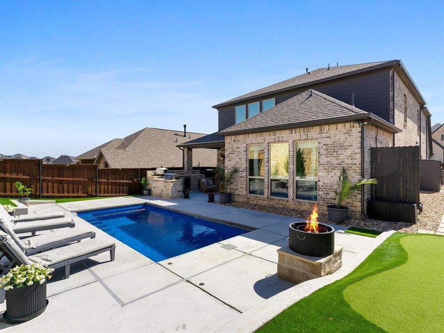 Vacay every day! Dive into your own private oasis this summer in this curated, like new home designed for comfort and outdoor living, offering a range of interior and exterior enhancements. Inside, the open living space features LED recessed lighting with a night light feature, and statement chandeliers above the pool table and grand foyer. A stunning 12-light spiral raindrop pendant chandelier with a dramatic high-ceiling design welcomes guests upon entry. While engineered hardwood flooring in the upstairs game room, office, guest bedroom, and primary bedrooms  complement the hardwood stairs. The kitchen is centrally located and features a high-capacity iSpring tankless reverse osmosis water filtration system for fresh drinking water. The garage features epoxy flooring, insulated doors, hexagon LED lighting, and a mini-split ac-heat pump for climate control.

The backyard is designed for entertaining and effortless living with a sparkling, fiberglass pool featuring 2 deck jets and 4 umbrella holders, surrounded by artificial turf with antimicrobial infill. The outdoor stone kitchen is equipped with a refrigerator, propane grill, pizza oven, and wood pellet smoker. Additional exterior features include a smokeless 26inch wood-burning fire pit, raised stone garden beds in the front and rear, stone borders around trees, crushed stone landscaping along both sides of the home with a 2x2 concrete paver walkway, French drain, putting green and extended concrete driveway. Outdoor lighting includes spotlights and fence lighting, along with a patio ceiling fan. Functional upgrades include retractable wall-mounted garden hose and extension cord reels, exterior GFI outlets, painted metal fence posts, and a whole-home generator hookup with exterior natural gas inlet and quick disconnect.

Residents enjoy access to community amenities including a neighborhood pool, clubhouse, jogging and bike paths, a park, and playground.
Schedule your private showing today!