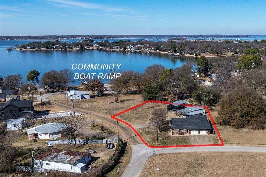 Beautifully maintained 3-bedroom, 2-bath residence offering picturesque lake views, ideally positioned on two prime corner lots at Cedar Creek Lake. This exceptional property combines comfort, functionality, and versatility. A heated and cooled detached garage provides flexible space suitable for a workshop, hobby area, private retreat, or potential conversion into guest quarters or a bunkhouse. The additional lot features a dedicated RV carport, offering convenient covered storage for a recreational vehicle or boat. The interior showcases a thoughtful blend of luxury vinyl plank, tile, and carpet flooring. The light-filled living area is open and inviting, creating an effortless flow for everyday living and entertaining. Adjacent to the living space are two well-appointed secondary bedrooms and a full bath, along with access to the kitchen and dining areas. The kitchen is enhanced by built-in shelving and a central island overlooking the dining area—ideal for gatherings. The spacious primary suite is privately situated apart from the secondary bedrooms, offering a peaceful retreat. Seller updates include HVAC, roof, gutters, and skylight. Foundation repairs were also completed in 2024 and are supported by a lifetime transferable warranty.