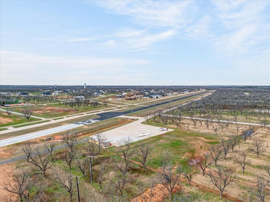 Discover the perfect setting for your aviation lifestyle at 1424 Cirrus Loop, located in The Landings at Pecan Plantation—one of North Texas’ most sought-after residential airpark communities. This exceptional 1.5 Acre homesite offers prime positioning with convenient taxiway access, allowing smooth aircraft movement and efficient departures and arrivals right from your property. Imagine the convenience of this scenario. With generous acreage and flexible building space, this lot is ideal for designing a custom hangar home tailored to your vision. Create the ultimate fly-in retreat with room for an expansive hangar, luxury residence, workshop, and outdoor living areas—all while maintaining privacy and functionality. Whether you’re an active pilot or an aviation enthusiast, this property provides the rare opportunity to live with your aircraft just steps from your door. The Beautiful Pecan Plantation Subdivision offers a gated, guarded lifestyle supported by a strong aviation community and a private paved runway designed for residential use. Residents also enjoy resort-style amenities including championship golf courses, a full-service marina on the Brazos River aka Lake Granbury, clubhouse dining, swimming pools, tennis,basketball and pickleball courts, baseball & soccer fields, disk golf, fitness facilities, parks, campgrounds, stables, archery range, walking and jogging trails, and year-round social events, as well as activity center classes & games. Additionally, you have a grocery store, gas station, bank, barber, hair stylist, pizza parlor & bistro, ems and fire department also in the community. Conveniently located just minutes from the historic Granbury Square, you’ll experience boutique shopping, dining, entertainment, and small-town charm while living in a unique fly-in community. Secure your place in this premier aviation development and build the hangar home and lifestyle you’ve always envisioned.