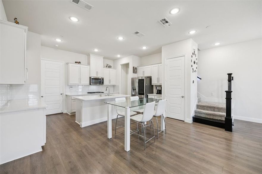 MOTIVATED SELLER. This pristine two-story townhome is all about location and low-maintenance living! Nearly new (built in 2021), this open and bright floor plan features no front neighbors and sleek modern finishes designed to impress. The thoughtfully crafted open-concept living area offers abundant natural light and flows seamlessly into the kitchen—perfect for everyday living and entertaining. The stylish kitchen is equipped with quartz countertops, stainless steel appliances, an oversized island with breakfast bar, generous pantry, ample storage, and contemporary cabinetry. A convenient guest half bath completes the first floor. The spacious primary retreat features a sleek modern ensuite with a separate standing shower and a large walk-in closet. You’ll also find oversized secondary bedrooms with excellent closet space. Additional Highlights: Upgraded garage door, installed water softener, and Smart home features that include a Smart Lock (automatic door lock) for the front door, and automatic climate control. HOA Benefits: Full yard and landscaping maintenance for a truly low-maintenance lifestyle. The amenity-rich community includes two pools, a pond, jogging trails, a park, clubhouse, and fitness center. Ideally located just minutes from I-635 and the President George Bush Turnpike, and only 10–15 minutes to DFW International Airport and Downtown Dallas. Nestled within the vibrant Mercer Crossing Corridor, you’ll enjoy a multitude of dining and entertainment options—including a spectacular 5,000-seat amphitheater with lake views.