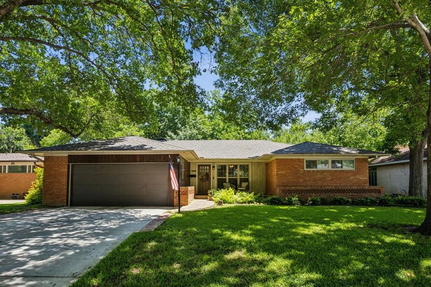 This inviting 3-bedroom, 2-bath home sits under a canopy of mature trees in the sought-after University Meadows neighborhood in East Dallas. Inside, you’ll find warm wood floors, tons of natural light, and a spacious open layout that’s great for everyday living or hosting friends and family. The kitchen features granite countertops, white cabinets, stainless steel appliances, a warming drawer, and a big island with bar seating. It opens right into the cozy living room with a brick fireplace and the dining area, making the space feel connected and comfortable. The primary suite features its own ensuite bath with dual sinks and a walk-in shower. Two more bedrooms give you options for guests, a home office, or whatever else to fit your needs. Out back, the large covered patio feels like your own private hangout spot—perfect for relaxing, entertaining, or catching the game on the outdoor TV. With string lights, great landscaping, and plenty of turf space, it’s a backyard you’ll actually use. Just minutes from White Rock Lake—with a trail leading right to it from the neighborhood—and close to all the local shops and restaurants East Dallas is known for.