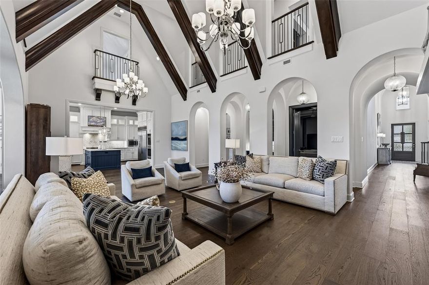 Stunning Highland Huntington Home in the gated Parkside community offering over 5,500 square feet of exceptional living space in the heart of Prosper. Designed for both everyday comfort and upscale entertaining, this impressive residence features a dramatic beamed great room with soaring ceilings and a breathtaking two-story living area filled with natural light from walls of expansive windows. Architectural details, including elegant archways, wood beams, and designer finishes, create a warm yet sophisticated atmosphere throughout. The chef’s kitchen is the heart of the home, showcasing abundant cabinetry, double ovens, expansive countertops, and a large center island that opens seamlessly to the living and dining spaces—perfect for hosting gatherings. A private study with French doors provides an ideal work-from-home retreat, while multiple living areas offer flexibility for relaxation, entertainment, and family living. The spacious primary suite offers a peaceful escape with a luxurious ensuite bath and generous closet space. Secondary bedrooms are en-suites and thoughtfully positioned for privacy and comfort. Step outside to enjoy a beautifully designed outdoor living area ready for a future pool, already equipped with an outdoor half bath ideal for entertaining or relaxing under the Texas sky. Located in the prestigious Parkside community, just minutes from top-rated Prosper ISD schools, Raymond Community Park, PGA Frisco, Universal Kids Resort, shopping, and dining. This exceptional home blends luxury, space, and convenience in one remarkable property.