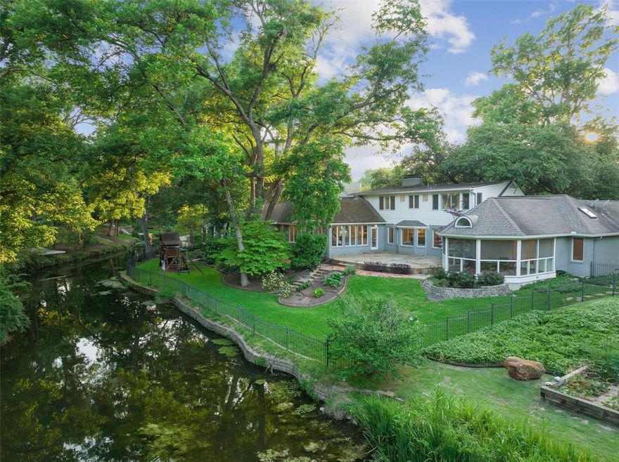 Enjoy rare creekside tranquility in the heart of the city near Hillcrest and Forest! More than a half acre of lush landscaping, towering trees and spectacular waters views along Buffalo Creek This traditional 4 bedroom beauty has floor to ceiling windows that bring the outside in! Light and bright with 170’ of frontage along a breathtaking creek and pond. Updated kitchen has marble counters, island, stainless high-end appliances. Master on first floor with attached screened in porch. Beautifully updated bath with Carrera marble, jetted tub, wine refrigerator and huge walk-in closet. Guest bedroom down with two generous sized rooms upstairs with jack-n-Jill bath, walk-in closets. Spacious great room joins 5th bedroom office with full bath. Lg laundry mudroom. Centrally located to highways. Minutes to Love Field, downtown and private schools.