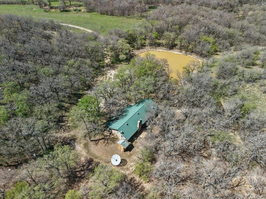 Come see your Agricultural and Recreational Dream Come True.  Priced to SELL.  Phenomenal Agricultural Exempt Legacy Wild Game Hunting Ranch with Small Lodge, that's ready for your customization and updates.  This land has loads of Deer, Hogs, Turkey, Birds and more. Natural and manmade ponds are in many places throughout the property.  You get to keep all the deer blinds and feeders too.  Cattle rancher is willing to continue the grazing lease in order to assist new owner with agriculture exemption as well. You'll find outstanding elevation changes, from a creek with FEMA floodplain to high rocky ridge tops.  The area around the private and fully equipped lodge is on higher elevation and has a private water well, septic, electricity, indoor fully ventilated smoker for your brisket and game, indoor stainless steel prep area, cold AC, fully functioning heating and so much more.  We personally photographed many groups of hogs, deer, and ducks on the ponds, and signs of wildlife throughout the entire property.  This ranch includes lush and fertile bottom land outstanding for grazing cattle, equine activities, pasture land, coastal or a wide variety of agricultural uses.  The property includes an enclosed barn for your equipment, an open hay barn near the hayfield, the land does have a few pumpjacks and tanks, and they're all located on the southern side of the land which keeps them separated and away from your agricultural, hunting and outdoor uses.