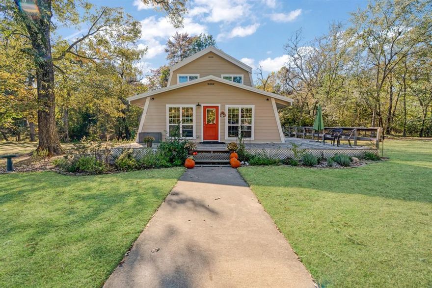 This charming home, set on nearly four acres in a tranquil environment, is located just one minute from Lamar Point at the popular Pat Mayes Lake and less than fifteen minutes from the scenic Paris, Texas. The residence features three bedrooms and two bathrooms, and has been thoughtfully updated and meticulously maintained. Its open floor plan is ideal for family gatherings and creating lasting memories, with both upstairs and downstairs living areas.  For culinary enthusiasts, the kitchen boasts stainless steel appliances, a gas stove, a custom farmhouse sink, and exquisite quartzite countertops. The bathrooms have been tastefully renovated, featuring spacious custom walk-in showers.  The home is adorned with beautiful hardwood floors, imparting a rustic charm. Outside, a large wrap-around deck provides an excellent space for entertainment, relaxation, and enjoying the great outdoors. Additional amenities include a 50x30 handyman's workshop for special projects, raised garden beds, a custom chicken coop, a new storm shelter, a fire pit, and ample room for children and pets to play and explore the woods and creek. The property also features a treehouse, zip line, and plenty of open space for various ball sports.  The close proximity to Pat Mayes Lake enhances the appeal of this property, making it perfect for water sports, exceptional fishing, or simply connecting with nature. This property truly checks all the boxes.