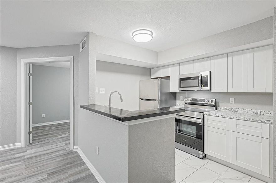 One-of-a-kind Condo located in Richland Trace Condos, minutes from shopping centers & significant Dallas highways & Richland College. Fully Remodeled with fresh paint throughout the condo, including walls & ceiling, new carpet at staircase & bedroom upstairs. This Gorgeous condo is fully equipped with a stacked washer & dryer. The kitchen was renovated entirely with appliances & resurfaced countertops, an attached coffee bar adjacent to the living room with open space & access to a balcony with an additional storage room. Open inviting layout from living room to kitchen. Very spacious and cozy. Outstanding condo & will make you feel