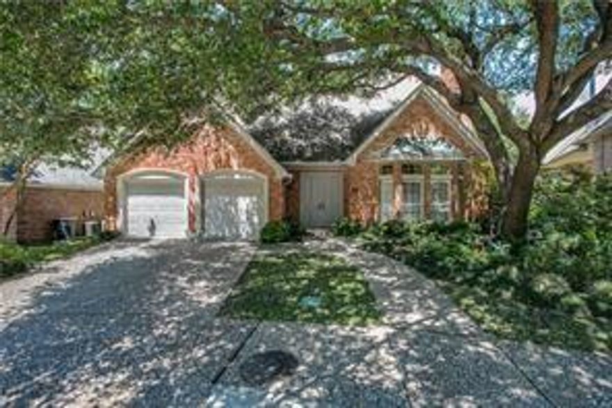Tucked away on a quiet, tree-canopied cul-de-sac, this beautifully updated 4-bedroom, 4-bath home offers the rare feeling of country living in the heart of the city. Inside, you’re welcomed by rich hardwood floors, classic millwork, and a dramatic staircase that sets an elegant tone from the moment you enter. Designed for both everyday comfort and effortless entertaining, the home features generous living spaces, large bedrooms, and an ideal layout that includes a dedicated home office. At the heart of the home is a stunning, chef-inspired kitchen—fresh, bright, and thoughtfully finished. Crisp shaker-style cabinetry stretches to the ceiling for a clean, custom look, complemented by quartz countertops, brushed-gold hardware, and a bold herringbone tile backsplash that adds a designer edge. A gas cooktop and double ovens make hosting easy, while expansive prep space and a functional layout keep everything within reach. The kitchen opens beautifully to the living and breakfast areas, creating a natural gathering spot for family and friends. The primary suite is a true retreat, highlighted by a refreshed bath with spa-inspired finishes. Out back, enjoy a serene greenbelt backdrop—a peaceful view that elevates morning coffee, weekend gatherings, and evenings at home. Perfectly positioned just moments from neighborhood favorites, including the White Rock Creek Trail, Fair Oaks Tennis Center, shopping, dining, and DART access, this home delivers the best of Dallas living—private, connected, and beautifully upgraded.