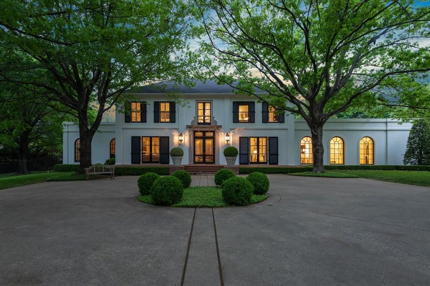 Exquisite custom-built classical stucco home designed by Bill Booziotis was taken back to the studs under direction of award winning LA based designers Chimera Interiors ca. 2017 to create one of the most strikingly beautiful homes in Dallas. Securely nestled on a quiet cul-de-sac lot in the centrally located Williamsburg Estates with mature Lamberts landscaping, this nearly 1.1-acre estate lives expansively. Gorgeous Negro Marquina and Carrara Marble entry floors flow into high ceilinged living areas with incredible art walls.  An Italian Dada kitchen by Molteni provides sleek design and efficiency with Miele appliances, all overlooking the saltwater pool and large grassy areas. The downstairs primary suite with French patterned hardwoods features one of the most exceptional bathrooms adorned with Negro Marquina and Thassos marble. Four to five additional suites offer flexible spaces for additional offices or living areas, all completely updated with marble, Vola and Fontana hardware.