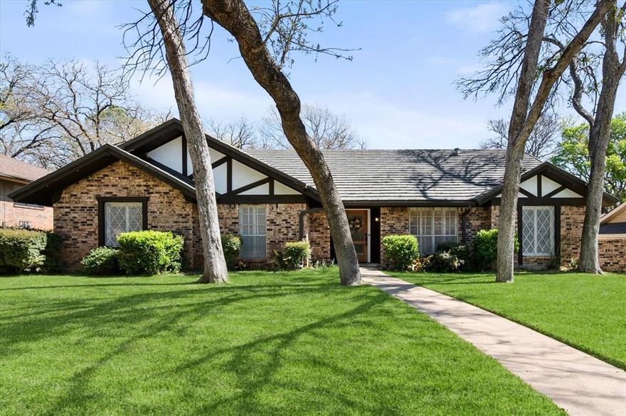 This is that special home you've been waiting for! Stunning, 4-bedroom home with tons of gorgeous updates in sought after Woodland Park Estates of Arlington, TX. As you approach the home, you'll be welcomed by the custom wood entry door. The natural stone floor accents the entry leading to a bonus room to one side which could be utilized as an office, additional living space or game room. As you proceed into the home, you'll be wowed by the vaulted ceiling, massive wood beams and spacious grand room highlighted by the wood burning fireplace and luxurious wood look vinyl plank flooring. The fully remodeled kitchen was opened up to feature a massive island, accented with beautiful quartz countertops which carried throughout the kitchen. The kitchen updates don't stop there...all cabinets, appliances, lighting, fixtures, and door hardware have been meticulously chosen to complete the fresh, clean look of this functional kitchen. There's more! Off the kitchen, you'll find a large space created to serve as a pantry, storage area, office, or a convenient location for your extra fridge or freezer. The dining space is large enough to accommodate a large table, and additional seating is available at the island. On the kitchen side of the home, you'll also find an ample utility room space and one bedroom with a half bath. The updates in guest bath include quartz counters, fixtures and tub surround as well as dual sinks. The primary bedroom is spacious and has a separate glass sliding door to the covered backyard patio space. If you love to entertain family and friends, the large backyard patio and added wood deck will be the favorite gathering space for everyone! Additional updates to this home will bring peace of mind and added efficiency to the home. These include the entire HVAC system, both water heaters, and improved electrical system. All attic insulation was completely removed and replaced for added home efficiency Schedule your showing today before this one is gone!