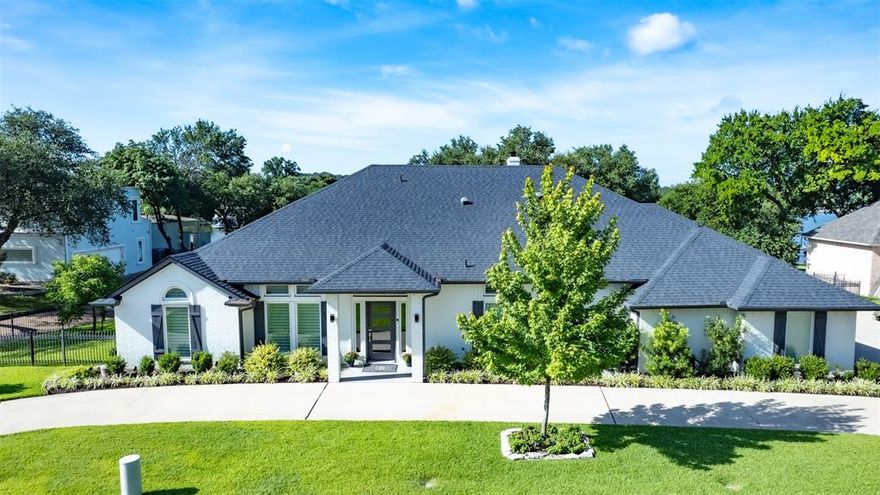 Beautiful one-level home on Eagle Mountain Lake waterfront! Located in Lake Country on coveted Carter Slough. Home has been beautifully remodeled and is ready to welcome you home with open concept kitchen to living, two primary bedrooms with en-suite bathrooms, two work-from-home flex spaces, large game room, new heated pool with direct pool access to half-bath. Kitchen has propane-powered gas cooktop, double ovens, all new Monogram appliances (propane also heats tankless water heater and pool). Primary en-suite bathroom has been recently remodeled with all the bells and whistles and bedroom has sweeping views of the lake. New outdoor kitchen enhances the functionality of the large back yard, pool and boat dock with jet ski lifts and storage; irrigation draws from Eagle Mountain and utilities are a dream with new blown-in insulation! 3-car garage and circular driveway provide ample parking. All refrigerators convey along with outside TV; boat and jet skis negotiable. 9 minutes to the new Sprouts grocery store; 24 minutes to Fort Worth stockyards and downtown. Schedule your showing today!