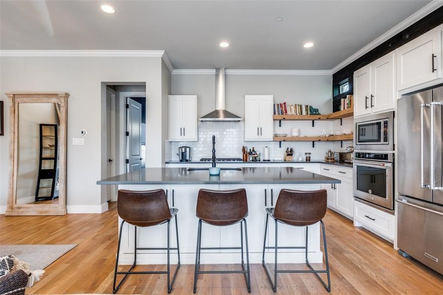 Welcome home to this contemporary end-unit townhome, under appraised value. This home offers a private first floor guest suite complete with an office space that can be used as a second living area. The second story greets guests and homeowners alike with abundant natural light and modern finishes throughout. The open concept kitchen includes an oversized quartz island, gas cooktop, Kitchen Aid appliances, extensive cabinet space, and a walk-in pantry. Off of the kitchen is an oversized primary bedroom, designed thoughtfully with roller shades and craft wallpaper to create a warm and inviting respite. The top floor opens to your private turfed terrace, complete with panoramic view of the Dallas skyline—perfect for sunset cocktails or morning yoga. Location provides convenient access to Downtown Dallas, Lower Greenville, White Rock Lake, and nearby dining and retail.