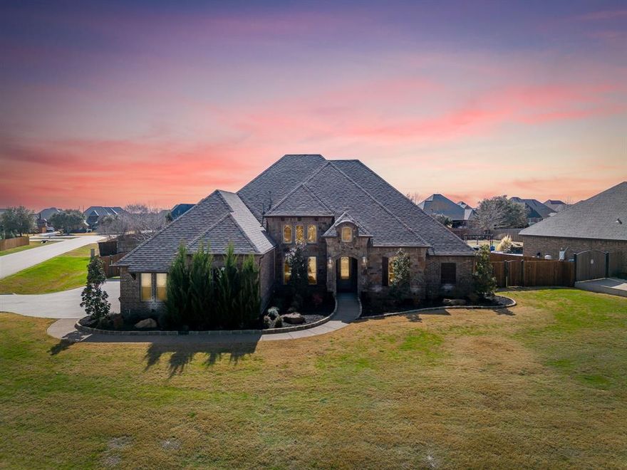 This home not only offers the space and privacy you've been dreaming of, but also has an incredible. long list of upgrades and updates. The large, .62 acre corner lot provides ample space for pets and kids to run, while the adults enjoy the shade of the oversized covered patio next to the inviting pool. You'll feel miles away - but are only a 20 minute drive to downtown Fort Worth - and in a great location to commute anywhere in DFW. The interior of the home offers a long list of custom features - like hand-scraped, solid hard wood floors through all living areas and bedrooms, custom cedar beams and a hand crafted, stone fireplace. The single story floor plan is ideal with a split bedroom arrangement. The primary suite enjoys views of the spacious back yard while the secondary bedrooms and guest suite all occupy their own, separate wings. High ceilings give the home a spacious feeling and provide ample natural light - all while maintaining a cozy, welcoming vibe. The kitchen is the star of the show with space to entertain a crowd. You'll appreciate the gas cooktop, double ovens and walk-in pantry - all accented by custom cedar beams and stonework. The secondary game room or living space offers a great spot to watch a movie or gives kids a spacious play zone. Recent updates include a luxurious primary bath makeover with a walk in double shower and free standing tub. The jack & jill bathroom features new high-end marble tile and gold fixtures. Other updates include: full spray foam encapsulation; new HVAC & dehumidifier system; recirculating tankless water heater system; 26kw automatic generator; new pool equipment; 500 gallon propane tank; smart switches throughout home; electric car charger. So many great upgrades - current owner has spent over $100,000 on improvements to the property in the last 3 years. This is an incredible opportunity for a new buyer!