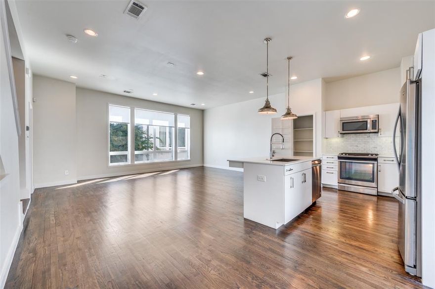 Move in ready and contemporary, this low HOA 3-story townhome sits in a secure gated community near Downtown Dallas, Knox Henderson, Lower Greenville, and White Rock Lake. The beautifully designed home features a 2-car attached garage, open-concept living area with hardwood flooring, and a private balcony off the kitchen perfect for relaxing or entertaining. The primary suite on the third floor boasts vaulted ceilings up to 16 feet, abundant natural light, and a sleek ensuite bath with marble tile and countertops. The third small bedroom with a closet next to the primary bedroom offers the perfect space for an office or hobby space, while the first-floor bedroom with a full bath makes an ideal guest suite. With modern finishes throughout and a prime location close to dining, shopping, and outdoor recreation, this home blends urban convenience with sophisticated living.