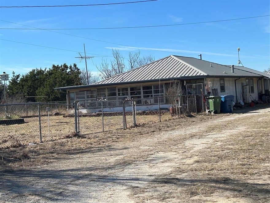 This is 2 acres;2 small mobile or motor homes will be moved off property. There are 2 other small old houses on the property, for a total of 3. Only the main house is livable. Has a 4-stall barn. Big well house, another large barn with medal roof, still in good shape. There are several structures on the property. 2- Separate water wells on each acre. 1 has a newly installed water filtering system. 1- propane tank with main house. This property is a good fixer upper and the location is great. The seller will be cleaning up and hauling off items off property before the sell is final.