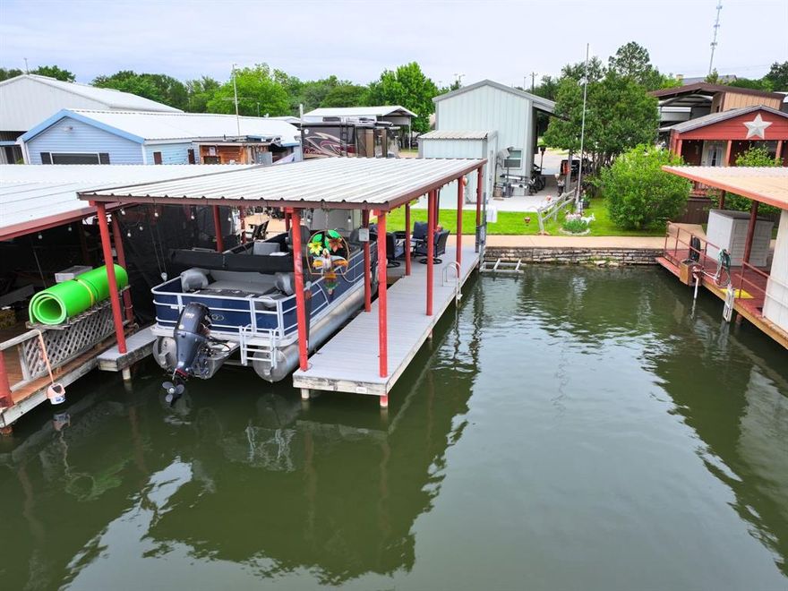 Elevated lake living awaits with this stylish barndominium-style studio combining comfort, versatility, and recreation. Perfect to bring your RV for an upscale weekend retreat or to make it your full time RV home, this waterfront escape offers effortless living with endless possibilities. The interior features a well-designed layout with a private bedroom or office complete with murphy bed, full bathroom, and loft, while two exterior storage areas provide ample space for lake toys and equipment.

Designed for those who love to play, the property includes dedicated RV parking and hookups, generous trailer space, and room to expand. Step outside to your private dock and enjoy boating, fishing, and unforgettable days on the water, then unwind in the tranquility of your surroundings. A storm shelter offers peace of mind, and best of all, you’re just minutes from the Historic Granbury Square, with its charming shops, dining, and entertainment. This is lake living—refined, relaxed, and ready to enjoy.