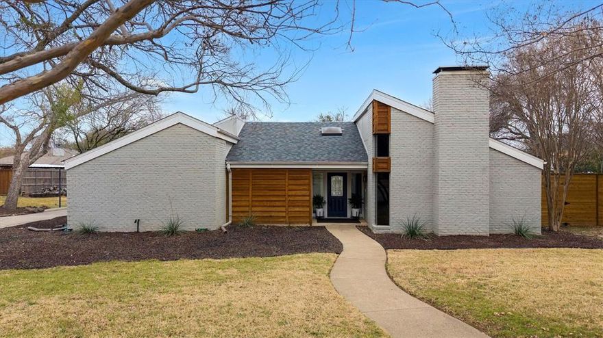 Entertainer’s dream with mid-century flair in the highly sought-after Marcus HS zone!
Zoned for McAuliffe Elementary, Briarhill Middle, and Marcus High School, this stunning four-bedroom, two-bath home blends architectural character with modern updates and exceptional functionality.

Step inside to soaring ceilings and an eye-catching living room anchored by a stately fireplace and built-in wet bar — the perfect backdrop for hosting gatherings both large and intimate. Opposite the entry, a light-filled dining space flows seamlessly into the updated kitchen, showcasing stainless steel appliances, quartz countertops, and a designer herringbone backsplash.

The rear wing of the home offers privacy and flexibility, featuring three generously sized secondary bedrooms, an updated full bath, and a conveniently located laundry closet.

The primary suite is a true retreat, highlighted by dramatic ceiling height, a striking wood-accent feature wall, and direct access to the private fenced patio and backyard — complete with a gate leading to serene creek access. The ensuite bath offers a soaking tub, separate shower, expansive closet space, and dedicated dressing area.

A recently-poured driveway offshoot leads to a large parking pad currently fitting an RV and boat, with the ability to accommodate a Class A Motorhome or other large vehicle.   The home also has an oversized two-car garage featuring built-in storage and durable epoxy flooring.

A rare blend of style, space, and versatility — designed for everyday living and unforgettable entertaining.