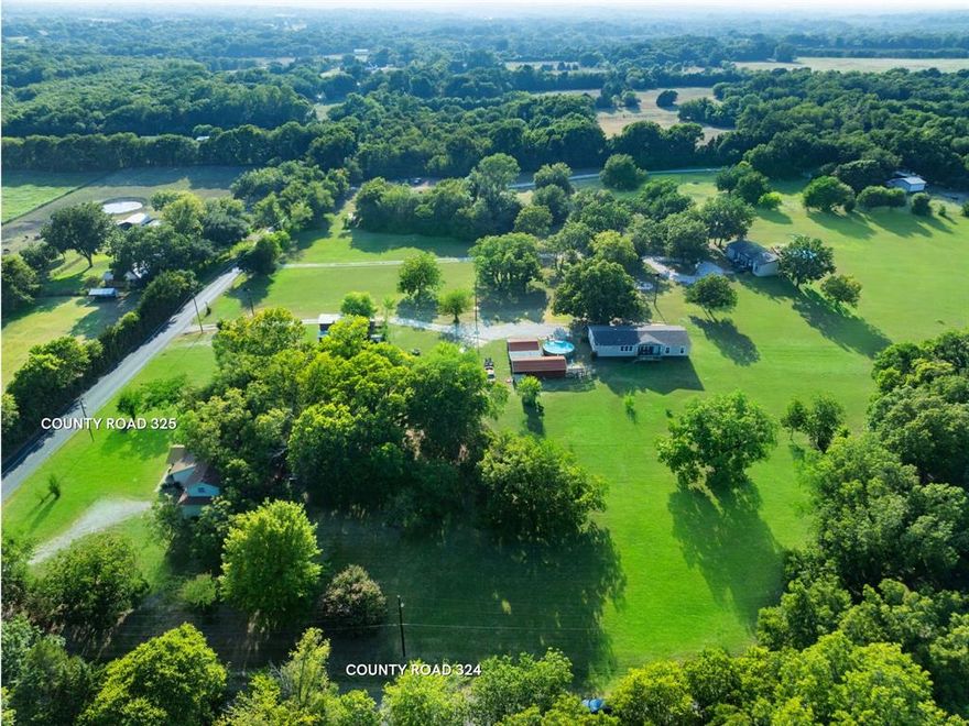 Hard Corner Land! Gorgeous 12.96 +l- ACRES with incredible LOCATION! Appr. 1,100 ft. road frontage, hard corner of CR 325 & CR 324, NO known restrictions. Desirable McKinney address, sits between the hub of McKinney National Airport, Fairview, Lowry Crossing, Heritage Ranch Golf Course & Country Club. Land is picturesque, natural tree line border, creek, pecan orchard is currently ag exempt. Property has 3 water meters, 3 septic systems, 3 electric meters from 3 homesites. 1 very nice mfg home, 1980 sq ft, 4 BR 2 BA & the original home. This property is surrounded by ranch type properties & luxury homes. Location & privacy could be site for dream home estate. Hard corner & flexibility could grab the interest of developers. This property offers flexibility as is, amazing land, minutes to Allen's Stacy Rd, Hwy 5 & all conveniences. It is a unique property, appreciated by generations, ready for the next. Mfg homes currently listed personal property.