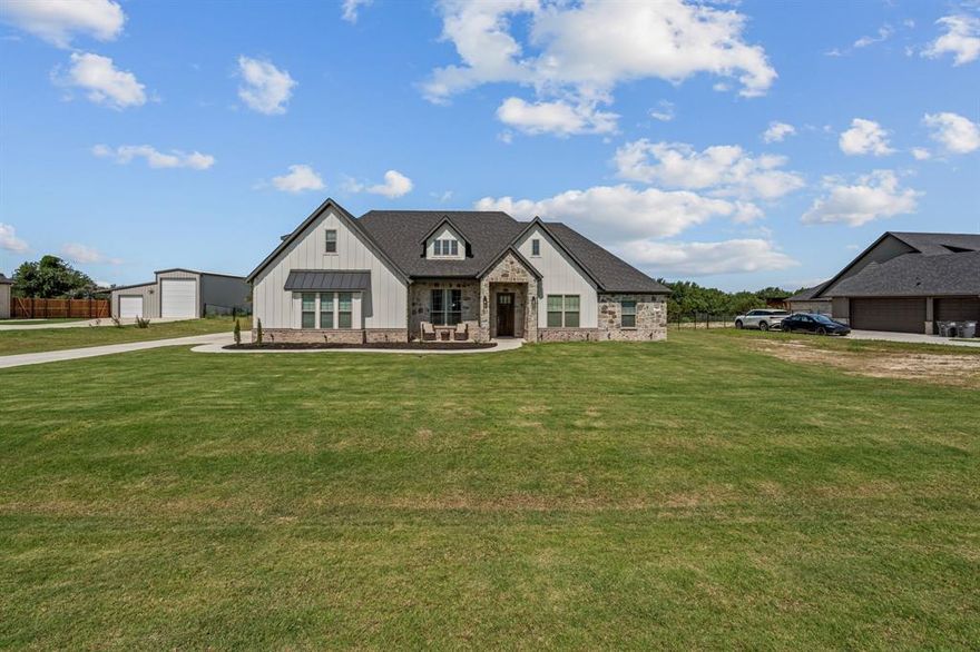 Welcome to this beautifully appointed home in Weatherford’s sought-after Vintage Oaks—a serene escape from the hustle of city life. Thoughtfully designed and full of upgrades, this charming Doug Parr home offers 3,031 square feet of versatile living space, including 4 spacious bedrooms—all conveniently located on the main level, and 3 full bathrooms. The heart of the home is its open-concept living area, where the kitchen, dining, and family room flow effortlessly together, creating an ideal setting for both daily living and entertaining. The kitchen shines with upgraded hardware and lighting, a large center island and walk-in pantry, while the family room features a warm wood-burning fireplace and plenty of natural light. Just off the main living area is a dedicated study, enhanced by a custom-built wall of cabinets and shelving—perfect for working from home or a quiet reading nook.
Retreat to the primary suite, your own private space, featuring an oversized shower, luxurious garden tub, dual vanities, and a spacious walk-in closet. Upstairs, a flexible bonus room with a full bathroom offers endless possibilities—think game room, media lounge, or even a private mother-in-law suite.
Step outside to enjoy a large covered patio with a built-in grill, overlooking wide open spaces and mature trees—ideal for outdoor dining, relaxation, and gatherings. The 3-car garage provides ample storage and convenience. Located in the tranquil community of Vintage Oaks, this property offers the best of both worlds—luxurious living and a peaceful setting, all while being close to the amenities of Azle, Eagle Mountain Lake and Weatherford. With generous front and back yards, there’s plenty of room for everyone to stretch out and enjoy.