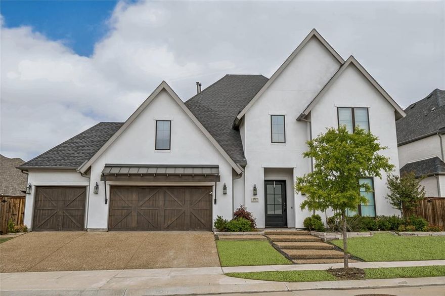 Welcome to this stunning 2022-built Toll Brothers home in highly sought-after Castle Hills offers 4,068 sqft of luxury living with 5 beds, 5.1 baths and 3-car garage on a premium greenbelt lot providing exceptional privacy. Thoughtfully designed 2-story floorplan showcases soaring ceilings, open-concept living & abundant natural light throughout. Chef’s kitchen is a true showstopper with oversized quartz island, matching backsplash, Sub-Zero fridge, Wolf appliances, double ovens, gas cooktop, commercial-grade vent hood, butler’s pantry & large walk-in pantry—perfect for entertaining. Expansive family room with fireplace opens seamlessly to the dining & breakfast areas, creating ideal flow for gatherings. Private primary suite down features spa-inspired bath with dual vanities, separate shower with double shower heads & spacious his-hers walk-in closets. All secondary bedrooms include ensuite baths + walk-in closets, offering comfort & privacy for family & guests. Upstairs features oversized game room with wood flooring & a dedicated media room with built-ins & surround sound. Thoughtful upgrades include new light fixtures throughout the home, designer island pendants, updated cabinet hardware, add'l mudroom storage & custom window shades. Additional features include engineered wood flooring & hardwood staircase, tankless water heater, sound system prewire, sliding patio doors & a covered outdoor living space overlooking a private backyard. Situated in an amenity-rich master-planned community with multiple pools, fitness center, parks, lakes, trails, tennis courts, playgrounds & on-site dining. Walkable to the community center & only minutes to major retail (Kroger, Target, Walmart, HEB coming soon). Quick access to Sam Rayburn Tollway & DNT. Approx 15 mins to Grandscape, Legacy West, The Star, Stonebriar CC, Gleneagles CC & Toyota HQ. Zoned for Lewisville ISD. This exceptionally maintained home offering luxury finishes, a prime location & an incredible lifestyle.