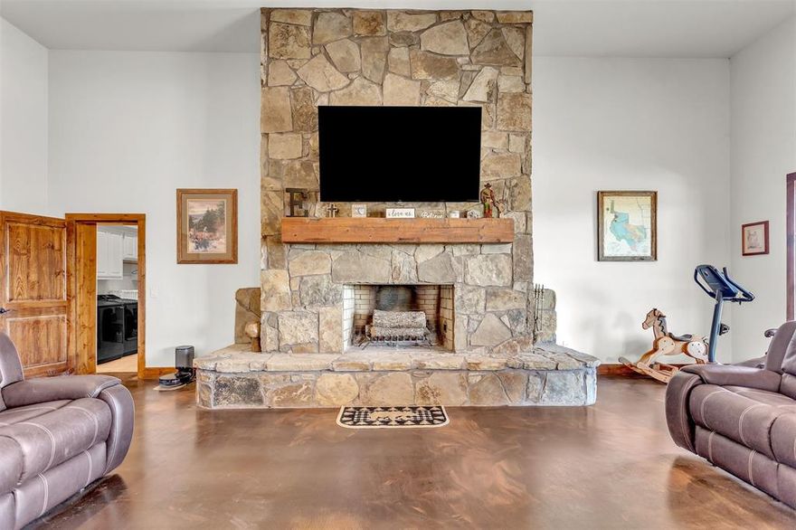 Unbelievable you can earn money on this five-acre ranch, while you enjoy lower taxes because of your AG Exemption. As you enter the ranch you will see the very large barn dominium home and large barn. A wonderful place to call home. Entering from side porch you come into the open floor plan with living area, kitchen and dining area. Livingroom with 14' Stone Bonanza style floor to ceiling fireplace with complete full hearth. Kitchen has abundance of cabinets. Kitchen sink is right below a window with a nice view. Counter tops are leathered granite, very large peninsula with many drawers and a hidden cabinet for the trash. Many cabinets and drawers for pantry by the Dining area. The S.S. fridge in kitchen can stay. End of hall has a large closet for more storage. Laundry room has water and a drain area for dog bathing place, where ice maker is now. (It will be removed.)  Sink in the laundry room with an area to fold and hang items. There are three good sized bedrooms, and full bathroom. There is a dry bar next to the media room. Primary bedroom has electric fireplace. Next is the great walk-in closet, it is amazing. Primary bath is so wonderful with double sinks and double vanities.  A very large double shower and jetted tub is set so you can enjoy the TV and fireplace. Ranch is AG Exempt, keeping taxes lower. Barn and pens are covered with fans for each pen. Large tack room, barn has electricity and water at the barn. Hot water heater too. Lights so you can work at the barn any time. The listing agent is related to the seller.