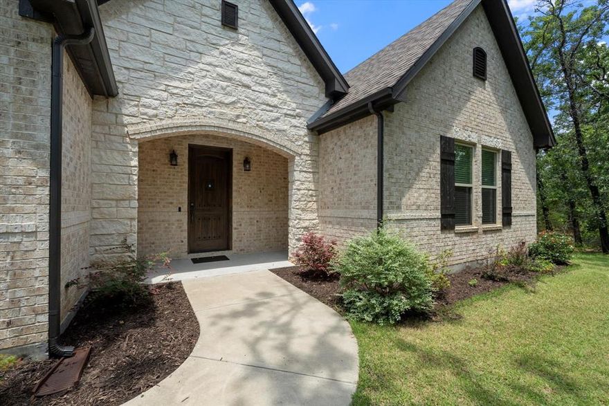 HIDDEN GEM nestled on beautiful, wooded acre in area of other nice homes on acreage! Experience peace and privacy in this stunning custom-built country retreat! This like-new white stone and brick home offers the perfect blend of rural tranquility and modern convenience. Low Tax Rate! Chickens allowed! A short drive to Rockwall and easy access to both I-30 and Hwy 276! Premium finishes throughout including solid 8ft doors, solid maple cabinetry, exquisite granite, and quality fixtures and lighting! Very open and huge living with 15 ft vaulted ceiling adorned with a rustic natural wood beam. The gourmet kitchen is a chef’s dream, featuring granite countertops, rich solid maple cabinetry, sleek stainless-steel appliances, a walk-in pantry, and generous counter space to inspire your culinary creations. Retreat to the very spacious primary suite with high ceilings and peaceful views of surrounding trees. Amazing very spacious ensuite bath provides large walk-in shower, separate vanities, maple cabinets, and granite countertops. HUGE walk-in closet for all your storage needs! Expansive laundry room with built-in cabinets and space for a freezer adds everyday functionality. Oversized 2-car garage with plenty of room for shelving. Plenty of room for RV or boat parking, and room to build a shop. Step outside to your private, fenced backyard oasis, where birds singing and rustling leaves create a soundtrack of solitude. Adjacent wooded 1 acre lot for sale. Come see for yourself and fall in love with your next home!
