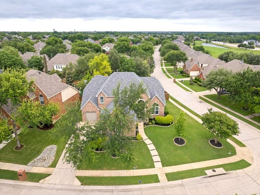 Incredible opportunity to own a beautifully maintained home situated on an oversized corner lot in the highly sought-after Stonebridge Ranch community! This thoughtfully designed floorplan offers both functionality and flexibility, featuring a Library or study, elegant formal dining room, and a spacious primary suite conveniently located on the main level.From the moment you step inside, you’ll appreciate the warm and inviting feel created by gorgeous engineered wood flooring that flows seamlessly throughout the main living areas and crown molding detail. Freshly updated carpeting (April 2026) adds comfort and a like-new feel to the secondary spaces. The heart of the home is the impressive kitchen, complete with an abundance of cabinetry, granite countertops, and a large center island that provides the perfect space for gathering and entertaining. Additional highlights include a gas cooktop, double ovens, and a built-in desk area just off the breakfast nook—ideal for staying organized or working from home.The generously sized downstairs primary suite offers a relaxing retreat, with an ensuite bath featuring dual vanities, a linen closet, and a well-designed layout that maximizes both space and functionality. Upstairs, you’ll find a spacious game room, convenient double staircases, and three additional guest bedrooms that provide ample space for family or visitors.Well laid out laundry room has room for storage and a freezer! Step outside to a lush, beautifully landscaped backyard that has been thoughtfully designed for both relaxation and enjoyment. Whether hosting gatherings or simply unwinding, this outdoor space is sure to impress. Completing the home is a highly desirable side 3-car garage, offering plenty of room for vehicles, storage, or hobbies.Solar panels as well all paid off!