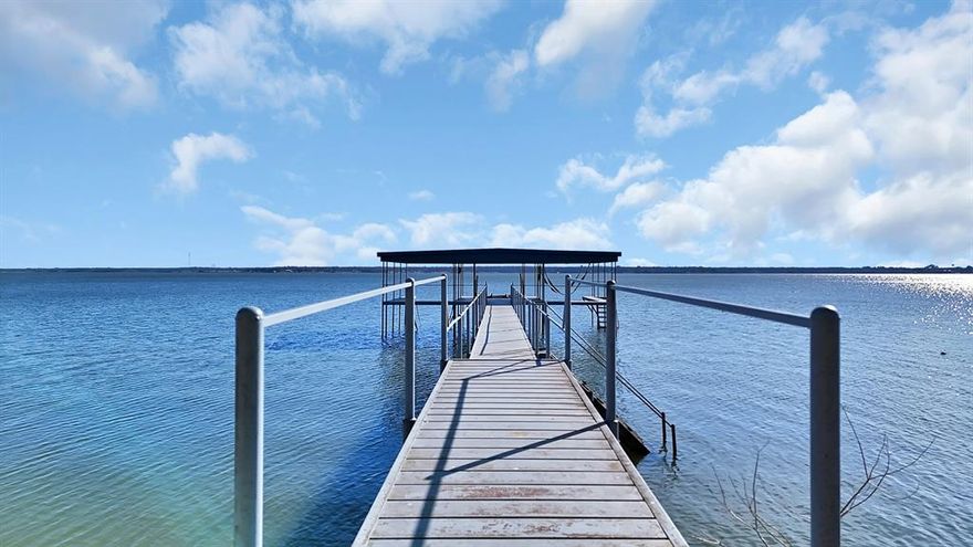 Welcome to paradise on Lake Tawakoni! This one of a kind gated waterfront estate is ideally located just outside city limits, meaning no city taxes and tucked away at the end of a quiet cul-de-sac. The property offers exceptional space and privacy with 0.34 acres owned plus approximately 2 additional acres leased from the Sabine River Authority, creating an expansive setting perfect for entertaining and relaxation. The main residence features hardwood floors, a spacious living area with a stunning fireplace, and expansive windows that showcase breathtaking lake views. The home includes two primary bedrooms with ensuite bathrooms, plus a third bedroom with convenient access to a full bath just steps away. A separate three car garage includes a fully equipped guest suite above, complete with a kitchen and full bathroom. Ideal for guests or additional rental income. An additional one car garage located by the home , great for storing your kayaks, fishing gear and lawn equipment. Outdoor living is unmatched with a deck that was rebuilt last year, featuring a built-in grill, hot tub, screened-in sunroom and fire pit in the patio , all designed to capture endless lake views. The impressive metal dock offers two boat slips, two jet ski slips, and swim ladders, making lake life effortless and enjoyable. Home is fully furnished and move in ready, offering a seamless transition for buyers interested in continuing the short term rental operation. Buyer and buyers agent to verify all information, including schools, utilities, measurements and restrictions.