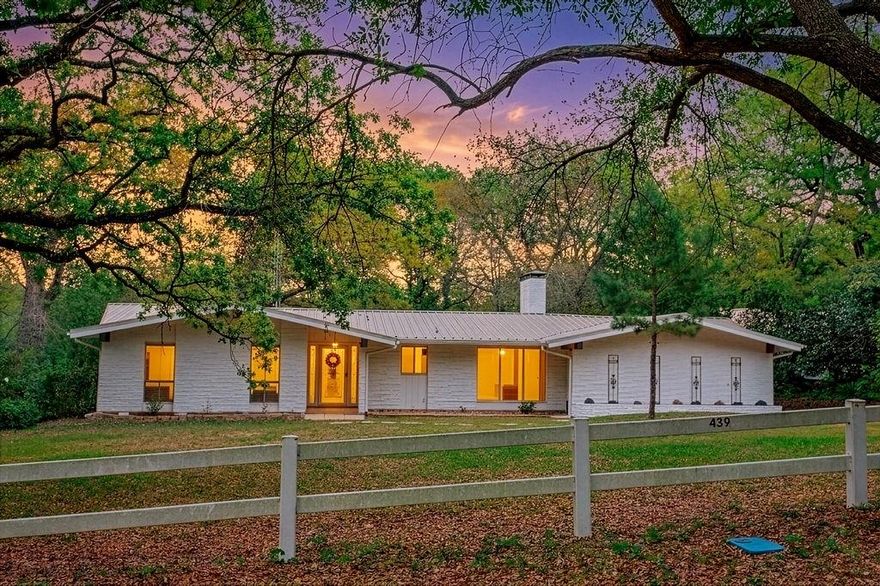 Beautiful mid-century modern home, a rare find in Hideaway! This freshly remodeled home features butcher block countertops with open concept kitchen and living area. Lovely black brick wood-burning fireplace makes for a dramatic focal point in the living area, perfect for chilly days. Luxurious spa-like bathroom for guests just off the hallway and a private one just for you off the cozy master bedroom. Oversized carport allows plenty of room for two cars and more plus an attached storage room in the carport makes for a great workshop or mancave and even has a shower for cleanup after doing yardwork! If you've been looking for a like-new modern home on a large lot, this one's for you!