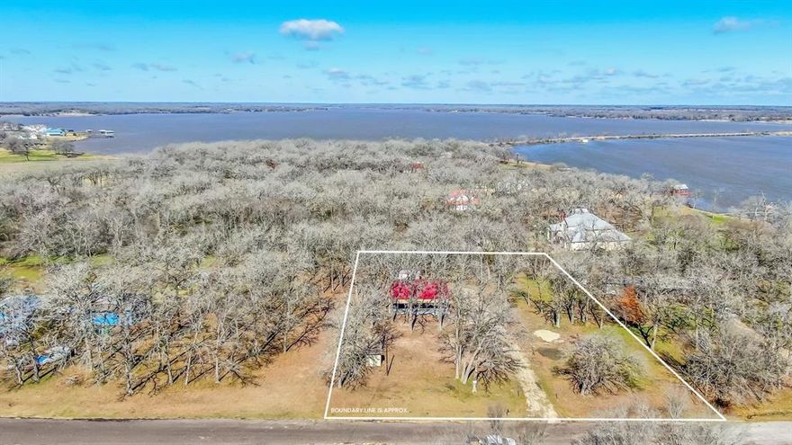 Beautiful and unrestricted 1.28 Acre property perfect for a home-site or recreational use located on the West side of Lake Limestone minutes from FM 3371 bridge.  Only steps away from lake access with a public boat ramp, dock, and picnic area, this property is a haven for outdoor enthusiasts.  Featuring a spacious 40x44 parking structure built in 2023, ideal for boat, RV or equipment storage.  With community water tap, additional private water well, electricity, septic system and privately owned propane tank--this property is ready for you to build your dream getaway!  Conveniently located less than an hour from Waco, about an hour from College Station and less than 2.5 hours from Houston.