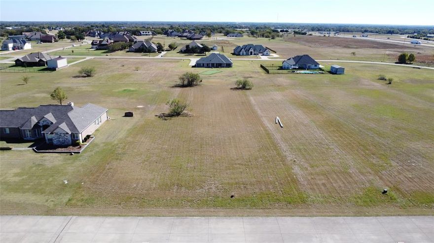 Build your family's country inspired home on this beautiful 1.16-acre interior lot in the prestigious Shadow Lakes community. This spacious homesite offers the perfect canvas for a custom residence surrounded by serene countryside views. Enjoy resort-style amenities including a beautiful community pool, private fishing lake, walking trails, and well-maintained common areas. Conveniently located near I-20 for easy access to Dallas and East Texas. Discover the ideal balance of sophistication, privacy, and accessibility in one of the most desirable neighborhoods.
