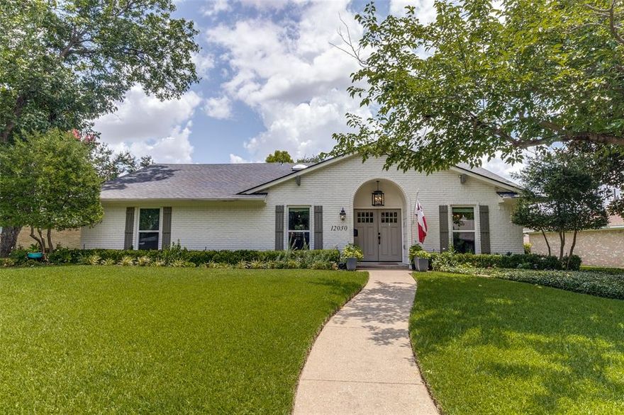 Located in the sought-after neighborhood of Lochwood, this beautifully updated soft contemporary home offers exceptional comfort and style and boasts fantastic curb appeal with mature trees and lush landscaping.  Step inside through an inviting set of double front doors to an open floorplan featuring a family room with a large wood burning fireplace, vaulted beamed ceiling, and skylights that fill the room with natural light.  The formal living room sets up as a cozy lounge sitting area has a sleek built in dry bar with wine refrigerator.  The updated kitchen has granite countertops, abundant storage space, stainless steel appliances package and a breakfast room.  The primary bedroom has a spacious ensuite bath and two closets. Numerous additional improvements and amenities reflect the care and attention given to this home, including a new roof in June 2025, updated windows, engineered wood flooring and covered back patio with firepit. Nestled in a friendly neighborhood with a park and tennis courts just down the street plus easy proximity to White Rock Lake, this home is a true gem!