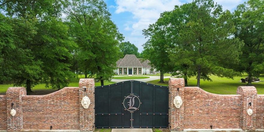 Welcome to your luxury estate nestled on 35.69 acres of pristine land in the heart of East Texas.  The property is just minutes from the LA Border.  This property offers a large 5 acre stocked lake with tons of different types of fish, amazing oak trees, and a custom built gazebo, here you will also find the ultimate in exceptional living that is surrounded by peace and tranquility.  The home boasts a parlor room, four spacious bedrooms, floor to ceiling windows overlooking the beautiful lake, 10 ft flat, 11 ft flat, and a 21 ft vaulted ceiling.  Barrell ceilings grace the entry and the primary bath.  The kitchen is a Chef's dream with double islands, leathered marble countertops, custom glass inlays, dovetail drawers, imported hardware and much more.  Also the kitchen has Thermador appliances, ample storage, and a large butler's pantry with marble backsplash and solid wood custom built cabinets.  Brazilian hardwood floors give this home the luxury feel you have been looking for.  Pair all of this with the restoration hardware fixtures, all custom wood moldings and you have a true luxury home.  As you approach this property, you will be immediately struck by the beauty of the custom hand carved granite lion heads accented along the nine foot to 14 foot brick roman style wall surrounding the solid iron custom gate.  The English bond, flemish bond, and herringbone patterns make this entry wall simply breathtaking.  It is truly a work of art.  The gated entry creates an impressive atmosphere that sets the tone for the rest of the property while feeling like you're the only people within miles of the place.  There is also a bridge that spans across the 5 acre lake that was the original railing restored from the historic Logansport bridge that connected Texas and Louisiana.  There is also a large deck by the lake for sunbathing while everyone else is trying to catch their fish of the day!  Do not miss your chance to own your own private retreat for you and your family!