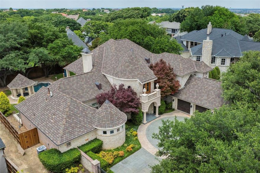 Enjoy this beautiful home with the tranquil backyard setting in a guard-gated community just minutes from all that Frisco and Plano have to offer.  The grandeur of the 2-story living room with a curved staircase, fireplace and dining room create an atmosphere of comfort and sophistication.  Just past the entry is a beautiful office with a full wall of shelves. The luxurious primary suite includes sitting area, see-through fireplace, updated bathroom which has 2 vanities and 2 toilet closets and features a workout area or nursery.  Make some memories hosting gatherings in the downstairs entertainment area with its game area, wet bar, media room and full bath.  Also downstairs is a cozy family room with fireplace and real rock wall and a private guest room.  The 2nd floor features a large game room with balcony, 3 bedrooms, 2 baths and desk area. Updates include Anderson energy efficient windows, paint, bathroom updates, lighting, pool resurfacing and heater and quartz countertops.