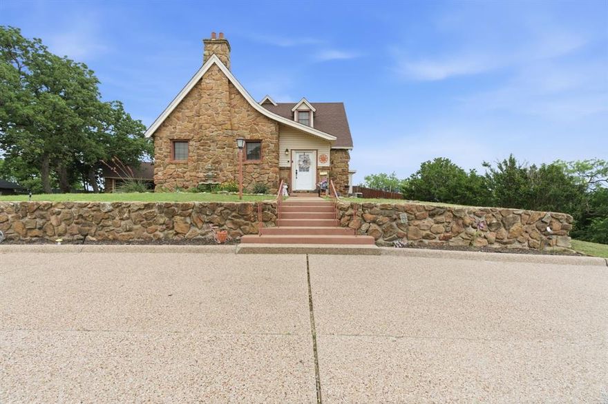 Step back in time and experience the charm of this truly one-of-a-kind Eastland gem. This 4-bedroom, 3.5-bath home offers over 3,400 square feet of character-filled living space, perfectly situated in the heart of Eastland with convenient access to local schools. From the moment you arrive, the Tudor-inspired stone exterior sets the tone for what’s inside. Step through the front door and you’re immediately welcomed by timeless details including original hardwood floors, multiple cozy fireplaces, custom lighting, beautiful built-ins, and gorgeous wood-beamed ceilings in the living area that add warmth and architectural character. The kitchen offers an abundance of cabinetry and storage, complemented by butcher block countertops and easy access to a formal dining room—perfect for gathering and entertaining. The first-floor primary suite features a spacious walk-in closet and an en suite bath with ample cabinet space, along with two additional bedrooms conveniently located downstairs. One of the most special spaces in the home is the stunning library or flex room, complete with stone walls and built-ins, creating the perfect place to unwind or host. Upstairs, the layout is ideal for guests or multi-generational living, featuring a large bedroom with en suite bath, a media room, and an expansive flex space that can serve as a second living area, game room, or home office. Step outside to enjoy a large backyard, a great patio space for entertaining, a garage, and additional storage. This home is truly a rare find in Eastland County—rich in character, full of charm, and ready for its next chapter.