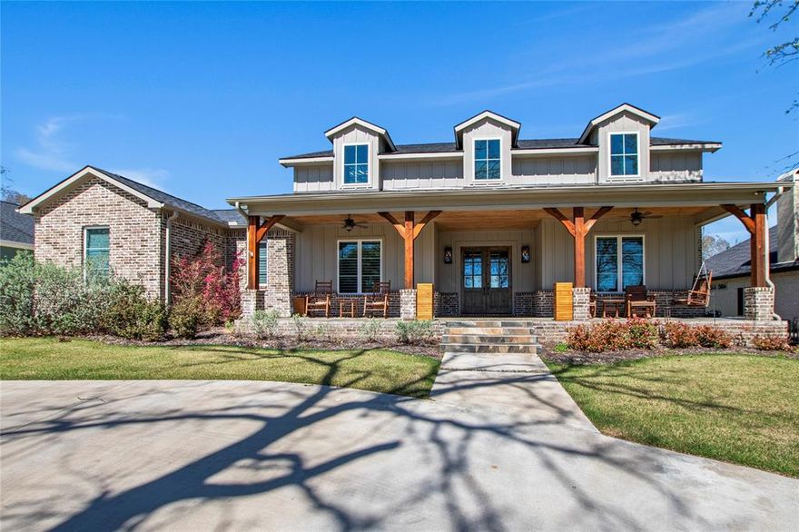 Stunning 4-bedroom, 3-bath modern farmhouse in the gated Pinnacle Club, built by respected builder Whiddon Homes. Situated on a large lot directly across from Cedar Creek Lake and the Pinnacle POA park, this home offers peaceful, unobstructed water views from the primary suite and spacious covered front porch. The open, light-filled floor plan features expansive windows, ¾-inch oak flooring in the main living areas and bedrooms, and tile in the bathrooms and laundry. The living room includes a gas fireplace and built-in speakers, with additional speakers in the game room, front porch, and back patio, all controlled by phone. The chef’s kitchen offers a Bertazzoni gas range, KitchenAid ice maker, quartz countertops, and abundant storage. The primary suite features water views and a bath with dual sinks, large shower, and a closet with built-in drawers, a safe and full size mirror. One guest bedroom includes an ensuite bath, making it ideal as a second primary suite, and the third bedroom has an ensuite bathroom that can also be accessed through the hallway. Additional features include a dedicated office, laundry room with sink and space for a full-size refrigerator, remote electric blinds in bedrooms, office, and laundry, and a game room or fourth bedroom with patio access. The covered back patio has electronic screens and is pre-wired for a fountain feature. Exterior highlights include a 2 car garage, 1 car garage, circle drive, fenced backyard, and large covered front porch. Located in Pinnacle Club, a guard gated community with restaurant, swimming pool, tennis, pickle ball courts, play ground, 19 hole golf course and boat launch. Pinnacle Marker #10.