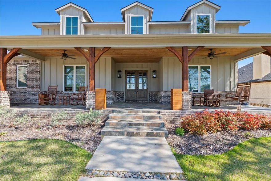 Stunning 4-bedroom, 3-bath modern farmhouse in the gated Pinnacle Club, built by respected builder Whiddon Homes. Situated on a large lot directly across from Cedar Creek Lake and the Pinnacle POA park, this home offers peaceful, unobstructed water views from the primary suite and spacious covered front porch. The open, light-filled floor plan features expansive windows, ¾-inch oak flooring in the main living areas and bedrooms, and tile in the bathrooms and laundry. The living room includes a gas fireplace and built-in speakers, with additional speakers in the game room, front porch, and back patio, all controlled by phone. The chef’s kitchen offers a Bertazzoni gas range, KitchenAid ice maker, quartz countertops, and abundant storage. The primary suite features water views and a bath with dual sinks, large shower, and a closet with built-in drawers, a safe and full size mirror. One guest bedroom includes an ensuite bath, making it ideal as a second primary suite, and the third bedroom has an ensuite bathroom that can also be accessed through the hallway. Additional features include a dedicated office, laundry room with sink and space for a full-size refrigerator, remote electric blinds in bedrooms, office, and laundry, and a game room or fourth bedroom with patio access. The covered back patio has electronic screens and is pre-wired for a fountain feature. Exterior highlights include a 2 car garage, 1 car garage, circle drive, fenced backyard, and large covered front porch. Located in Pinnacle Club, a guard gated community with restaurant, swimming pool, tennis, pickle ball courts, play ground, 19 hole golf course and boat launch. Pinnacle Marker #10.